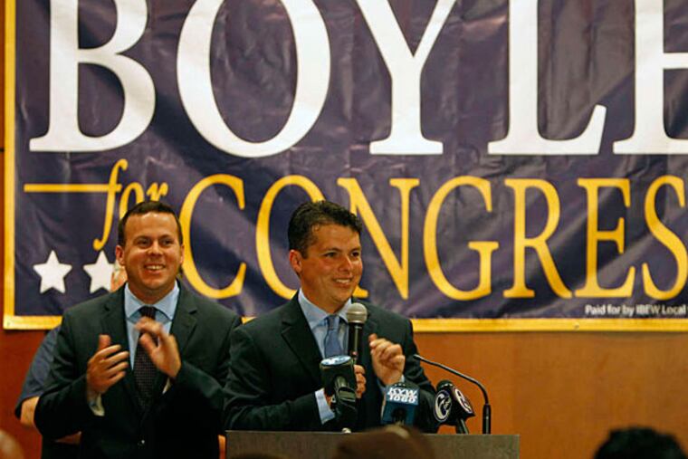 Brendan Boyle celebrates at the lectern , flanked by his brother Kevin, at the Heroes Ballroom of Fraternal Order of Police Lodge No. 5. RON CORTES / Staff Photographer