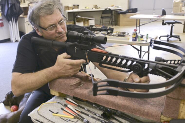 Chuck Matasic, president of Kodabow, tests one of his crossbows in his W. Chester facility. He sees a growing use of crossbows in hunting. (Ron Tarver / Staff Photographer)