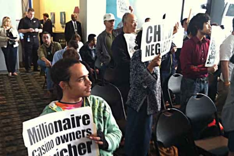 Members of the coaltion, "No Casino in Our City," protest the licensing of a second casino at a hearing before the state's Gaming Control Board, held at Lincoln Financial Field's Red Zone Lounge. Staff photo by Jennifer Lin