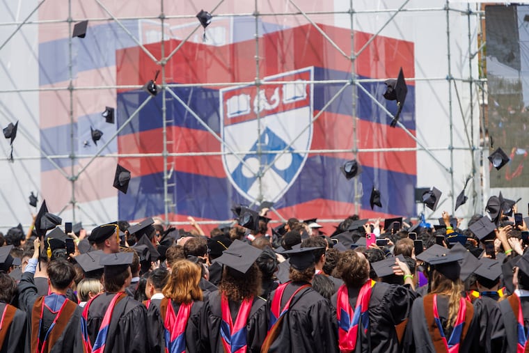Graduates from the University of Pennsylvania class of 2024 throw their caps into the air at the end of the May 2024 graduation ceremony on Franklin Field.