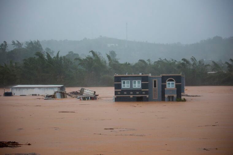 A home is submerged in floodwaters caused by Hurricane Fiona in Cayey, Puerto Rico, on Sunday.