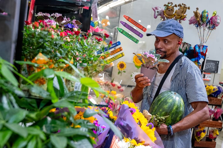 Camden resident Ryan Crews looks for a flower for his mother as he shops at the ShopRite in Cherry Hill Tuesday, Aug. 4, 2026. Camden is a food desert and doesn't have any grocery stores. Pastor Amir Khan is on a mission to help residents eat healthier and with a grant from Feed New Jersey, he is picking up residents and transporting them free of a charge to a suburban store.