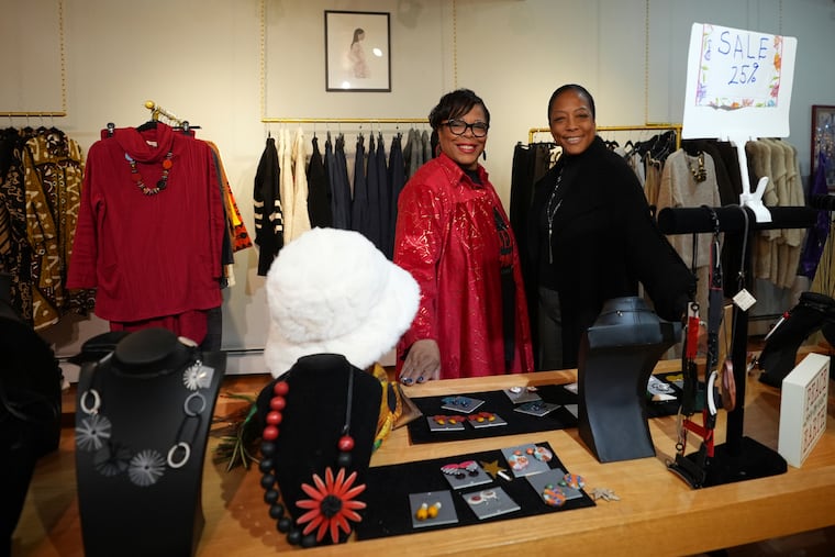 Claudia Averette (left) and her daughter Atiya Smith pose for a photograph at their shop, Between Friends Boutique, Wednesday, Dec. 11, 2024, in the Chestnut Hill section of Philadelphia.