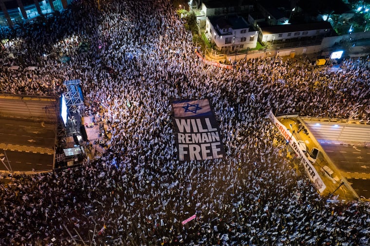 Tens of thousands of Israelis protest plans by Prime Minister Benjamin Netanyahu's government to overhaul the judicial system in Tel Aviv April 15. Trudy Rubin, who's covered the region for four decades, writes, "I’ve never seen such deep and visceral divisions over whether Israel will remain a democratic state for its Jewish citizens."