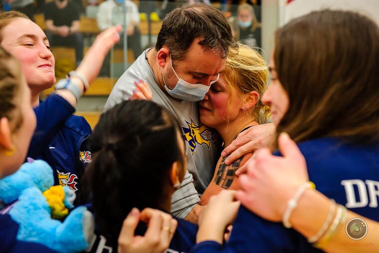 Members of the Drexel squash team celebrate their victory over No. 2 Trinity on Saturday.