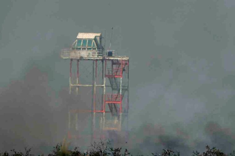 Smoke from a fire surrounds an observation tower at the Warren Grove Gunnery Range, Little Egg Harbor Twp., in '07.