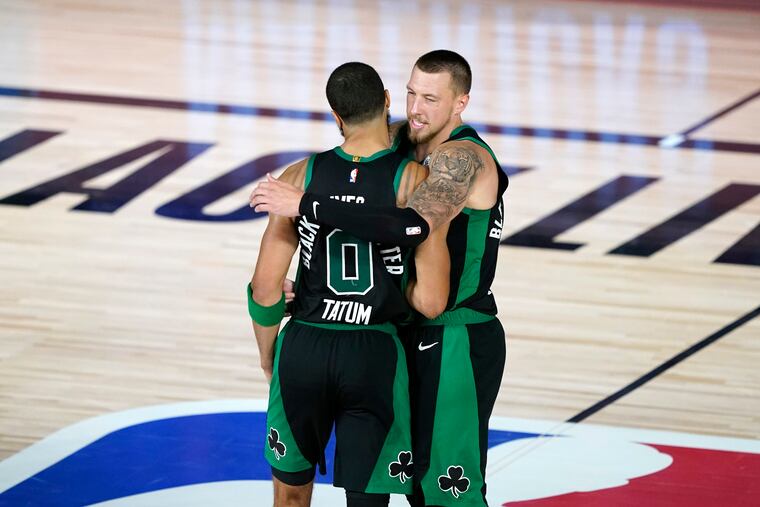 Boston Celtics Jayson Tatum (0) and Daniel Theis celebrated after the Game 1 win over the 76ers.