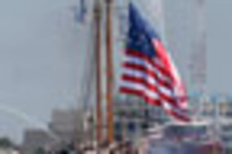 The Coast Guard tall ship Eagle leads other tall ships and escort vessels into Norfolk harbor as the schooner Virginia unfurls the flag of 1812 during a parade of sail for OpSail 2012 in Norfolk, Va., Friday , June 8,, 2012. (AP Photo/Steve Helber)