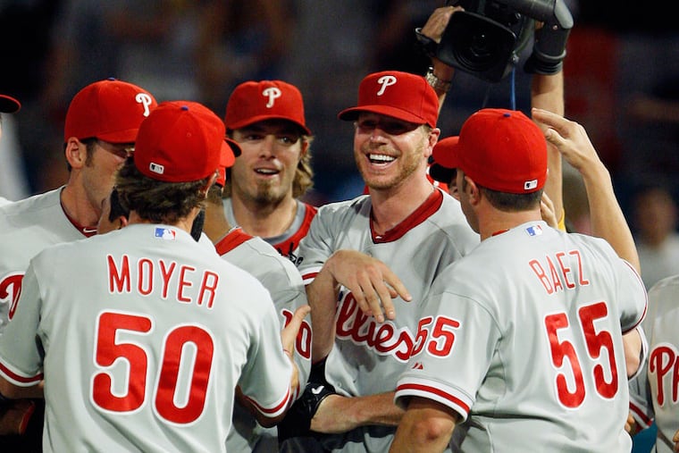 Roy Halladay (second from right) is mobbed by Phillies teammates after throwing a perfect game against the Marlins on May 29, 2010, in Miami.