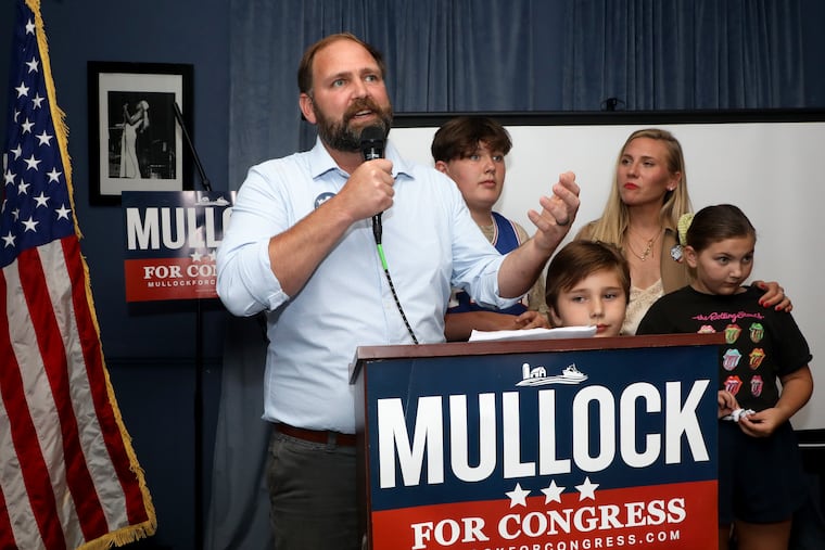 Zack Mullock speaks to supporters surrounded by his family after winning the 2nd Congressional District Democratic primary.