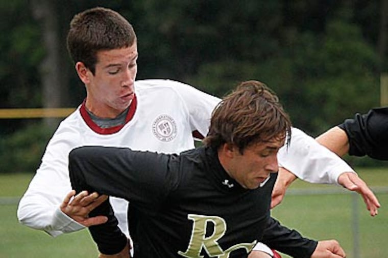 St. Joseph's Michael Carr and Roman's Mike McKinley battle for the ball. (Michael S. Wirtz/Staff Photographer)