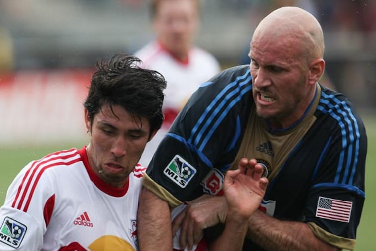 Union forward Connor Casey (right) battles for the ball with Red Bulls
defender Kosuke Kimura. (Andrew Renneisen/Staff Photographer)