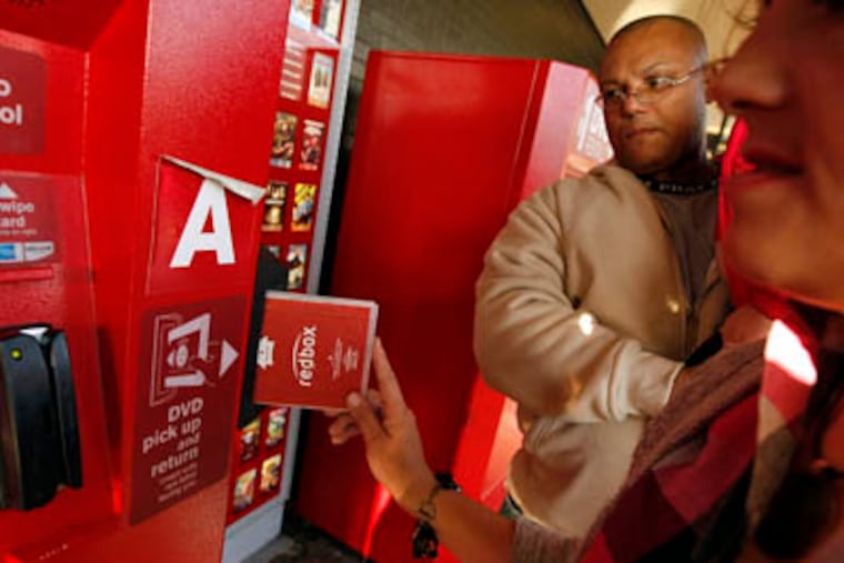 FILE: Enrique Cruz, left, and his wife Darlene Cruz return some DVD's at the Red Box movie rental vending machines outside Tony's Finer Foods on 4600 W. Belmont, Oct. 6, 2009, in Chicago, Illinois. (Phil Velasquez / Chicago Tribune / MCT)