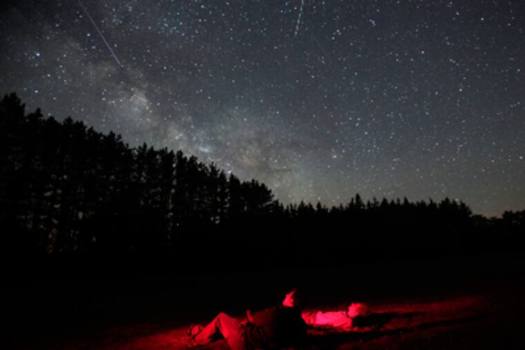 Ari Bach, 31, and Aaron Schaefer (right), 34, both of Washington, view the Milky Way at Cherry Springs State Park, a spot in northern Pennsylvania that is remarkably free of light pollution. (David Swanson / Staff Photographer)