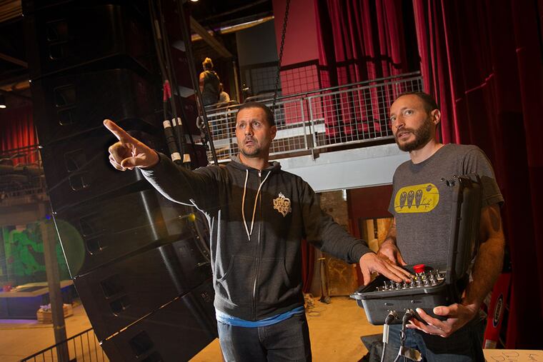 Dan Schartoff (left), Live Nation vice president of production, and Dustin Green, a project manager with the Lititz, Pa.-based sound production company Clair Bros., set up the sound system. (ALEJANDRO A. ALVAREZ/Staff Photographer)