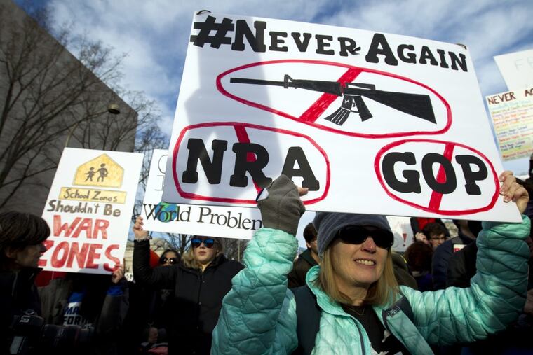 Becky Barger of Cornelius N.C., holds a banner during the “March for Our Lives” rally Saturday in Washington.