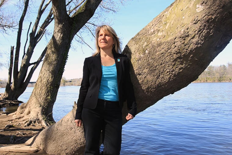 Maya van Rossum, The Delaware Riverkeeper for 20 years, stands along the banks of the Delaware River just north of Yardley. \ Her organization, The Delaware Riverkeeper Network is a brash, pitbull of a group that's prone to taking names and filing lawsuits. They fought dredging the Delaware and lost. They fought the state's new drilling law, Act 13, and won. ( CHARLES FOX / Staff Photographer )