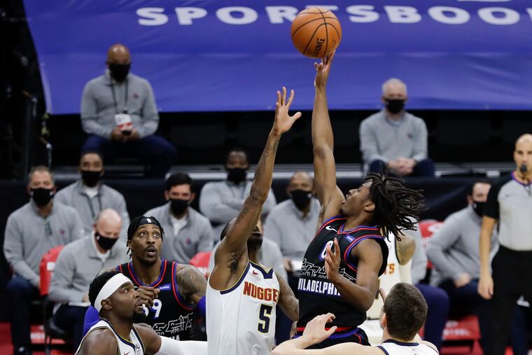 Sixers guard Tyrese Maxey shoots over Denver Nuggets guard Will Barton during Saturday's game.