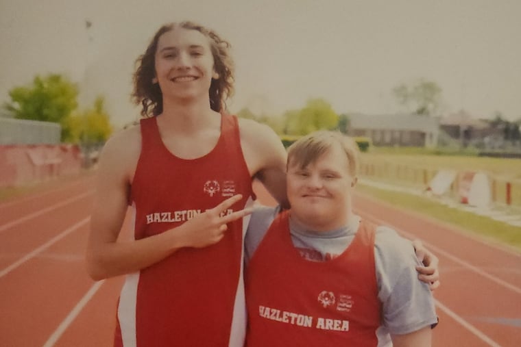Bryce Wolfe (left) with his brother Tyler, who has Down syndrome, while they were both students at Hazleton Area High School. Bryce and Tyler participated in sports together in a school program that was recognized by the Special Olympics.