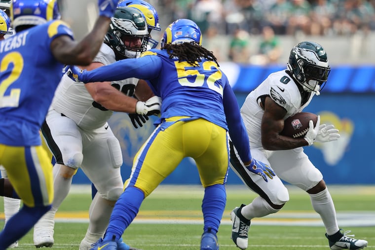 Eagles running back D'Andre Swift attempts to run for a second-quarter first down with Landon Dickerson blocking Los Angeles Rams defensive tackle Larrell Murchison at SoFi Stadium in Inglewood, California on Sunday, Oct. 8, 2023.