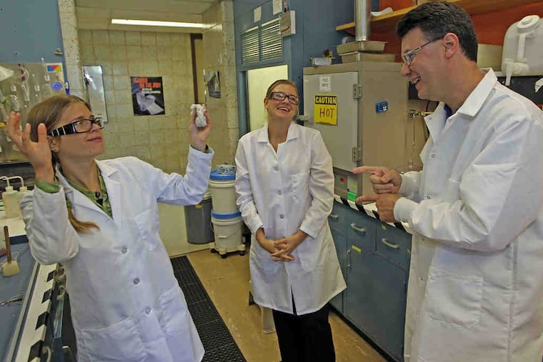 Melody Frink (left) and Mary Sporman chat with supervisor Scott Willis at Dow Chemical in Spring House. Willis learned American Sign Language in grad school, when he had two deaf friends.