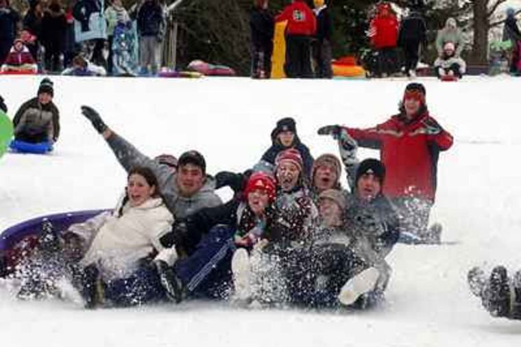 Friends from Holy Cross High School turned a snow-day into five hours of sled-riding at Stokes Hill. (Sarah Glover / Staff Photographer)