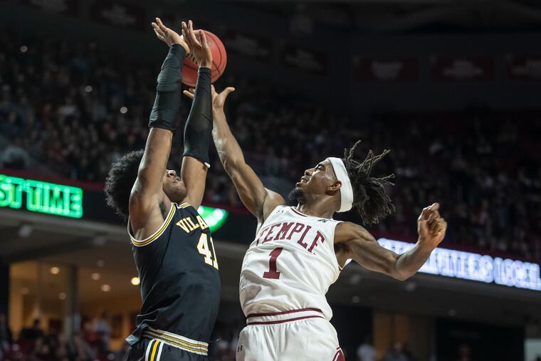 Temple's Quinton Rose (right) lifts his shot at the halftime buzzer past Villanova's Saddiq Bey to give Temple the lead, 30-26, at the Liacouras Center on Feb. 16, 2020.