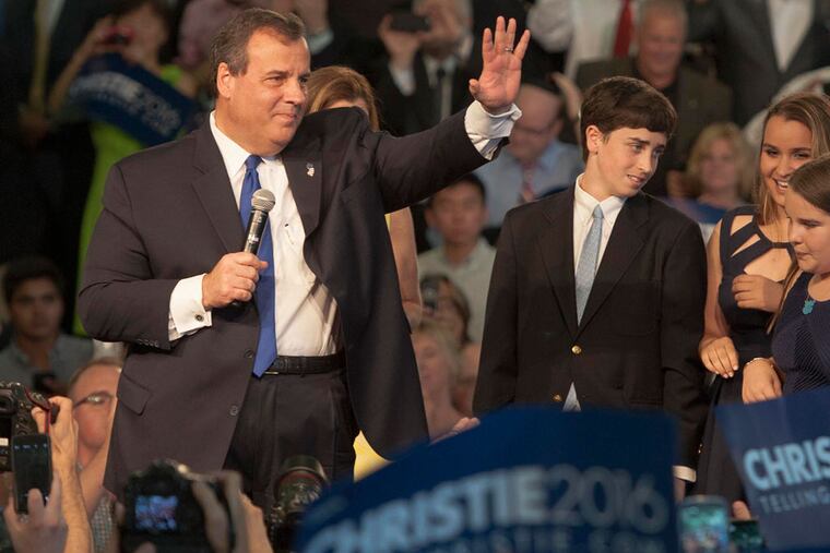 NJ Gov. Chris Christie acknowledges the cheers as he and his family -- wife Mary Pat (behind the Governor) and children (from left) Patrick, Sarah, Bridget (front) and Andrew -- enter the Livingston High School gym, Livingston, NJ, June 30, 2015 where he announced his candidacy for the GOP nomination for President in 2016. ( CLEM MURRAY / Staff Photographer )