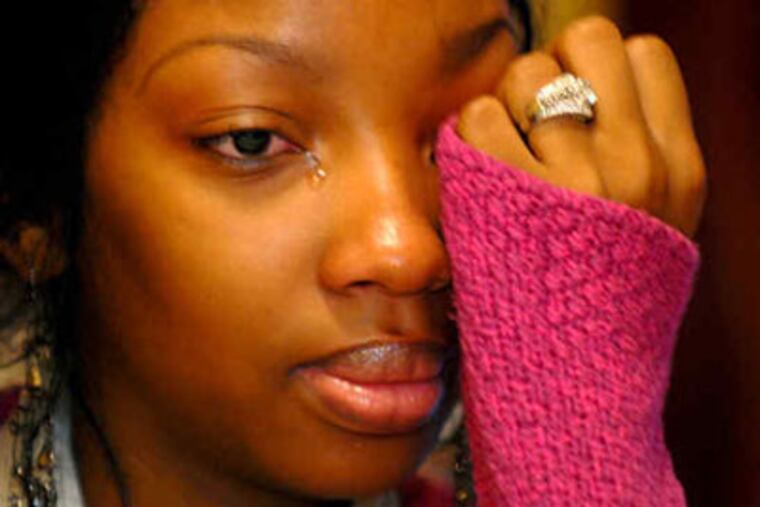 Tiana Drummond-Phiri tells an interviewer at her parents' home about the fight and aftermath. (Tom Gralish / Staff Photographer)