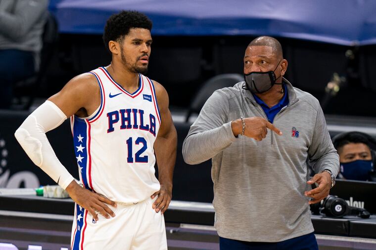 Tobias Harris, left, listens to head coach Doc Rivers during the first half of Wednesday's game vs. the Boston Celtics.