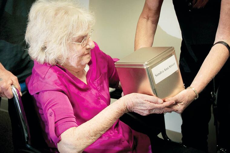 Elizabeth Stiver receives the urn containing the ashes of her daughter Sandra, who ran away from home in 1968 at age 14 and was later found dead, but remained unidentified until last month.