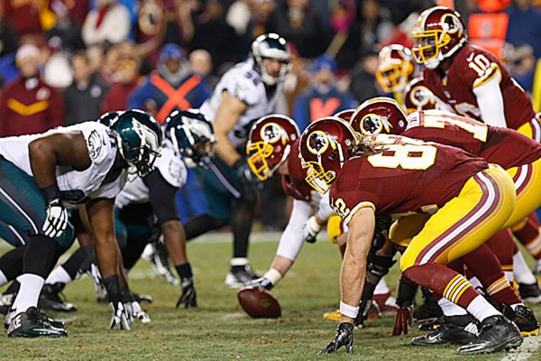 Redskins offensive players line up against the Eagles defense. (Geoff Burke/USA Today Sports)