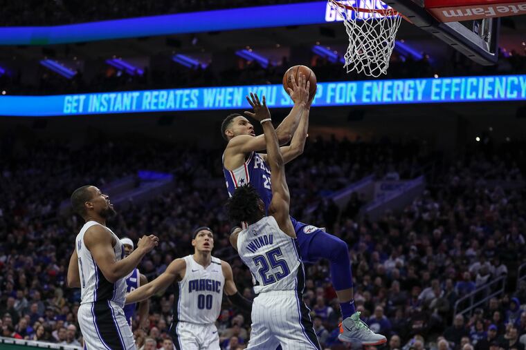 Sixers guard Ben Simmons drives to the basket and draws a foul in the fourth quarter of Tuesday's game against the Orlando Magic.
