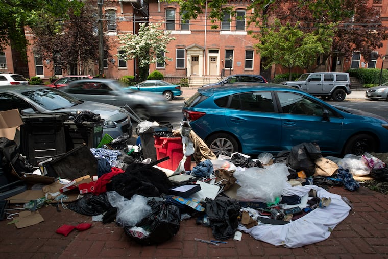 A large pile of trash on 42nd Street near the University of Pennsylvania campus on Tuesday. After the university's graduation, piles of furniture and garbage often appear near off-campus housing as students move out.