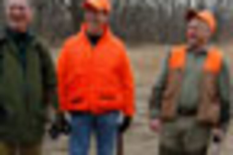 Republican presidential candidate, former Pennsylvania Sen. Rick Santorum, center, Rep. Steve King, R-Iowa, right, and Dave Funk, Polk County republican co-chair talk after a hunt at Doc's Hunt Club in Adel, Iowa, Monday, Dec. 26, 2011. (AP Photo/Chris Carlson)
