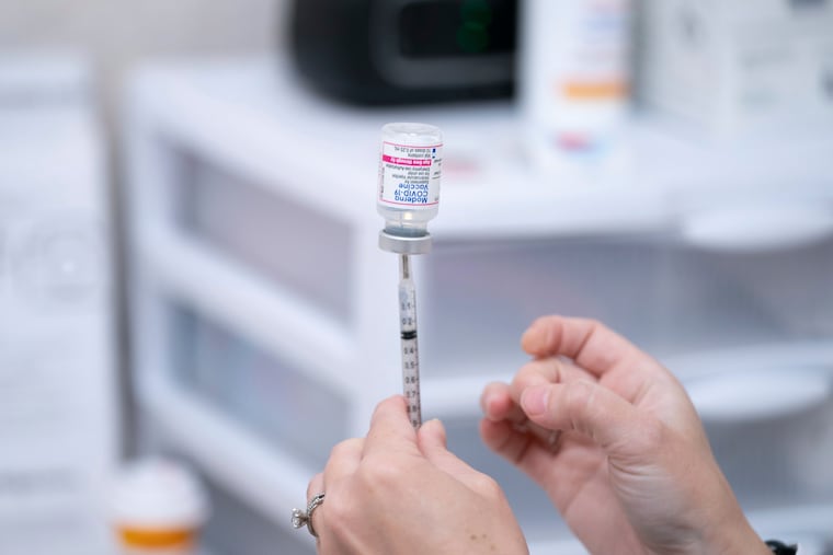 A pharmacist prepares a dose of the Moderna COVID-19 vaccine at a pharmacy in Lexington, S.C., in 2022. Falling demand for the shot and hostility from the Trump administration led to Moderna's stock falling nearly 90% from its peak.