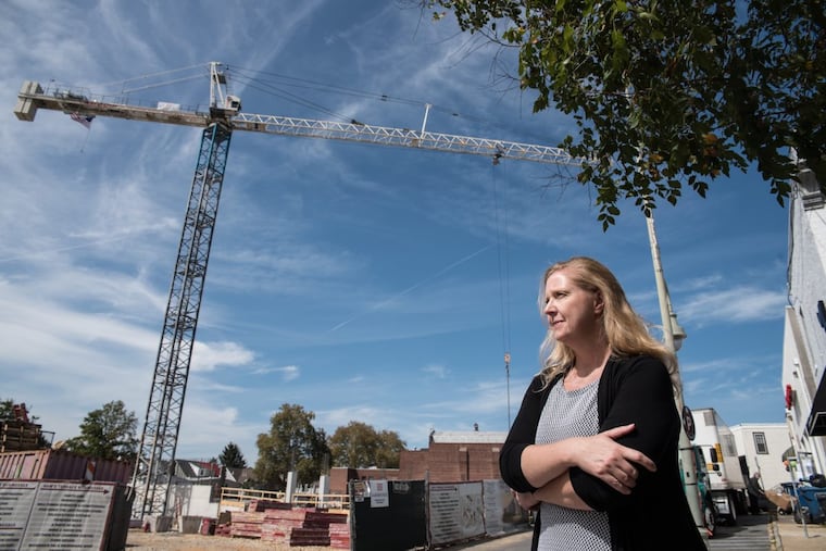 Business owner and activist Carrie Kohs surveys the construction site for a controversial mixed-use project just off Lancaster Avenue by developer Carl Dranoff that will bring residential units and retail to downtown Ardmore.