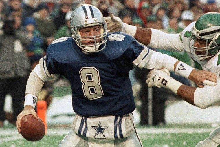 Troy Aikman, here trying break free from Mike Pitts, started 23 games against the Eagles. He was 10-11 in the regular season, but 2-0 in the playoffs.