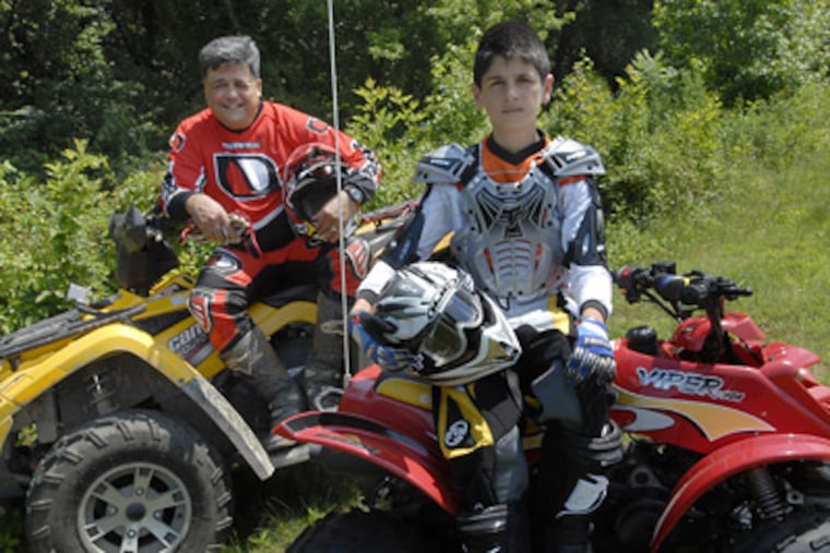 Dale Freitas and his son Stephen, in Burlington County, N.J.. Freitas said a lack of legal ATV tracks forces riders onto public land. (April Saul / Staff Photographer)