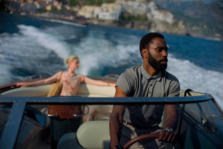 Elizabeth Debicki, left, and John David Washington in a scene from "Tenet."