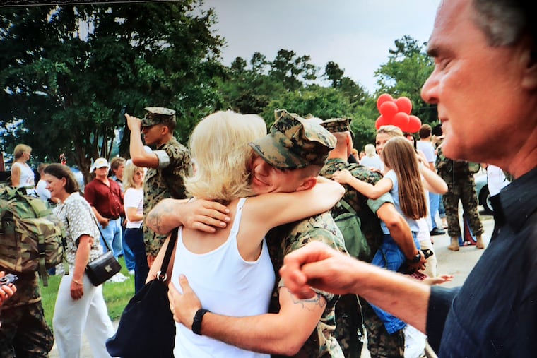 A family photo of Ryan Presutti hugging his mother, Maryellen, after returning from duty. Presutti, who served as a machine gunner in the Marines, was found dead in his Alabama trailer in 2016. The manner of death is disputed.