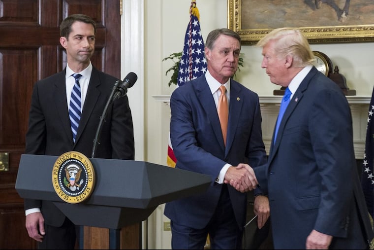 President Trump shakes hands with Sen. David Perdue (R., Ga.) during introduction of the RAISE Act last week as Sen. Tom Cotton (R., Ark.) watches.