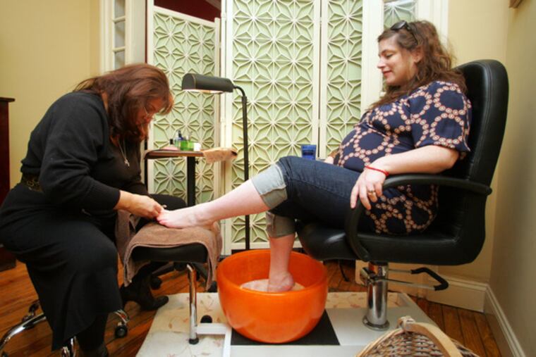 At JuJu Salon in Center City, Jennifer Storey gets a vegan pedicure from Lisa Rogers.