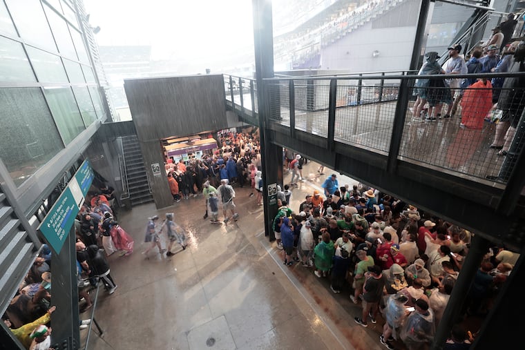 Fans during a rain delay of the France vs. Iraq World Cup match on Monday.