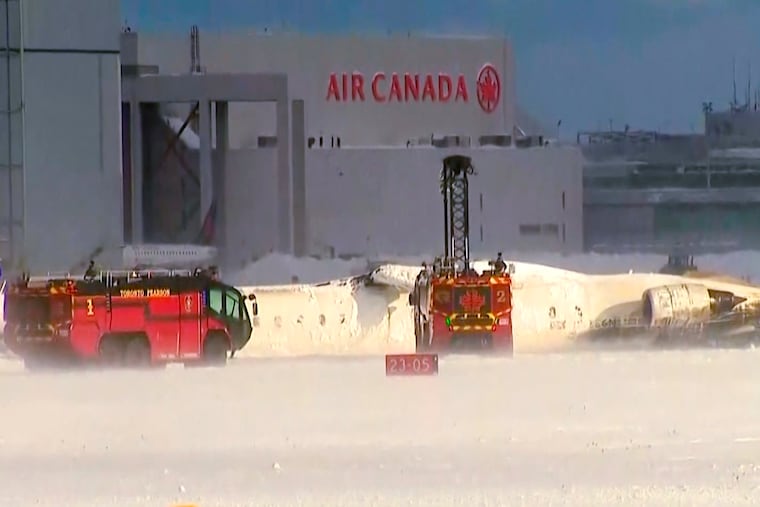 This image taken from video provided by CTV shows emergency crews responding at Toronto Pearson Airport after a plane crash on Monday.