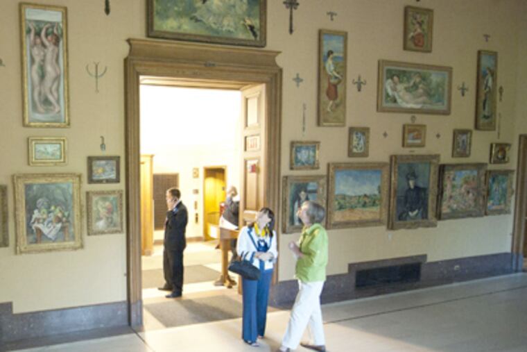Conservationist Barbara Buckley (right) and docent Beth Ann Kessler linger on the Barnes' last day in the building it called home from 1922. (Clem Murray / Staff Photographer)