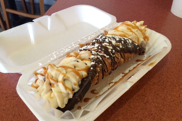 A chocolate-dipped, chocolate chip-filled cannoli from Cafe Crema in Philadelphia. ( Michael Klein / Philly.com )