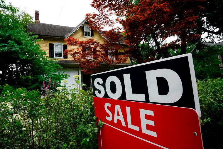 A sale sign stands outside a home in Wyndmoor in 2022.
