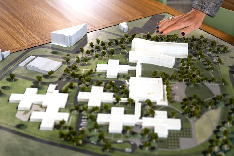 Isabel McDevitt, executive director of the Office of Community Wellness and Recovery, points to a model with upcoming expansion at Riverview Wellness Village, a city-owned drug recovery home in Northeast Philadelphia.