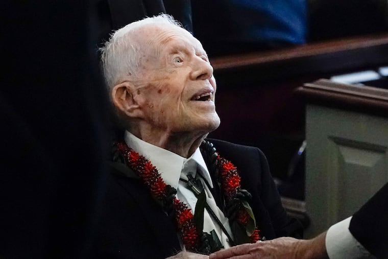 Former President Jimmy Carter greets attendees as he departs the funeral service for his wife, former first lady Rosalynn Carter, at Maranatha Baptist Church in Plains, Ga., on Nov. 29, 2023.